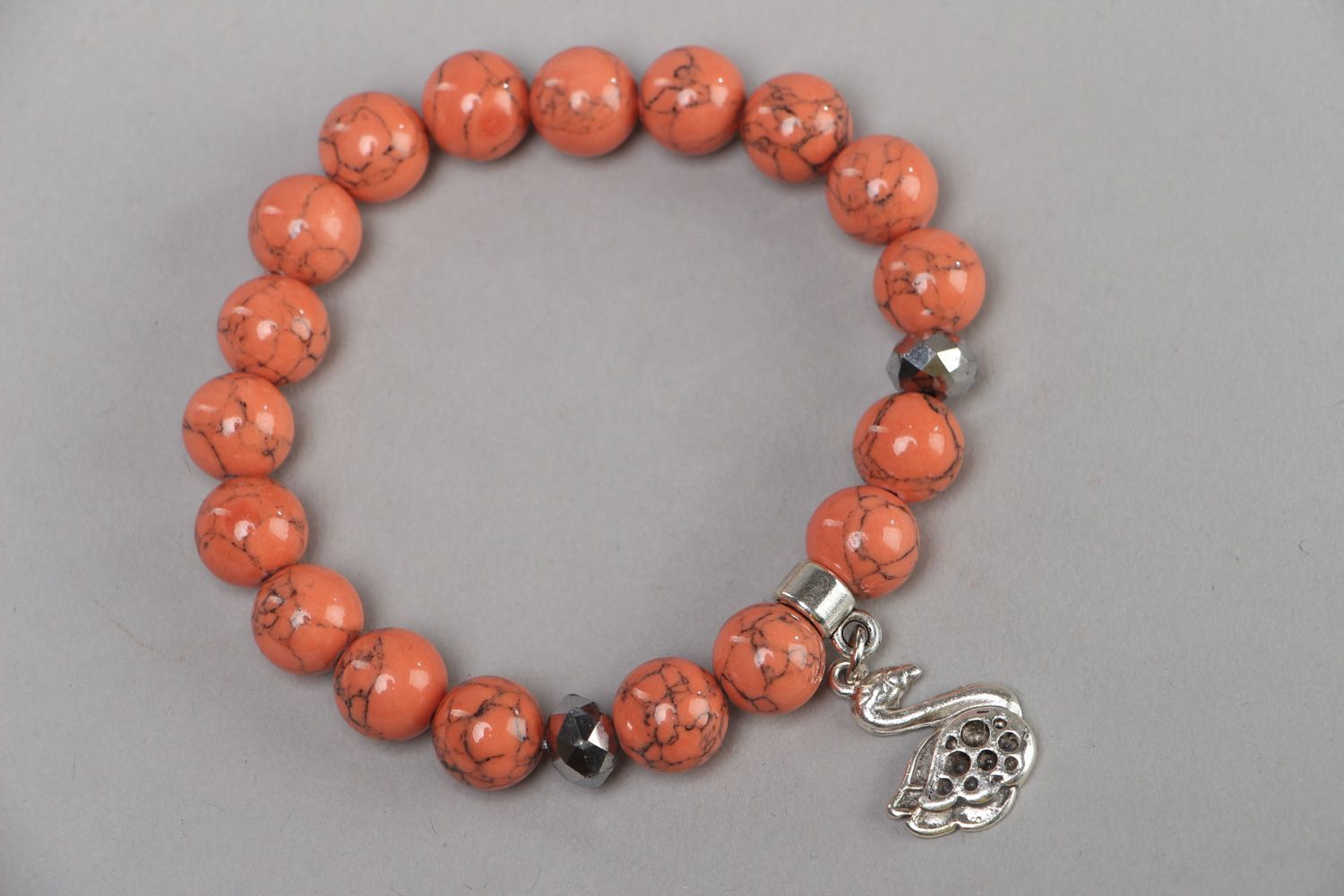 Handmade coral bracelet with metal charm in one turn photo 2