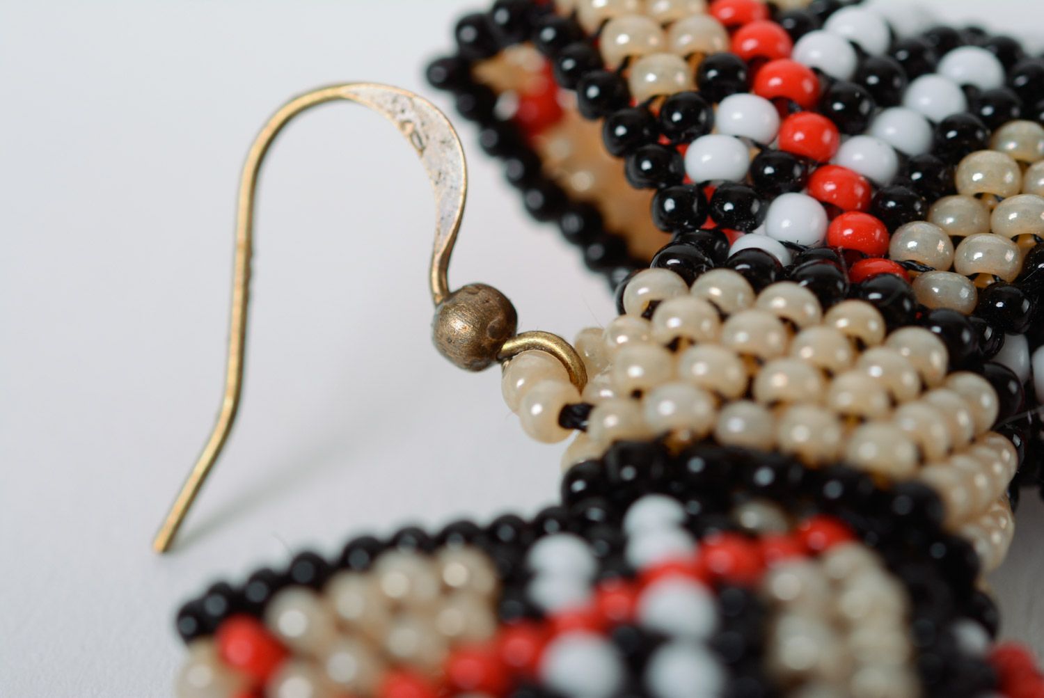 Handmade dangle earrings woven of beads beige checkered bows for girls photo 5
