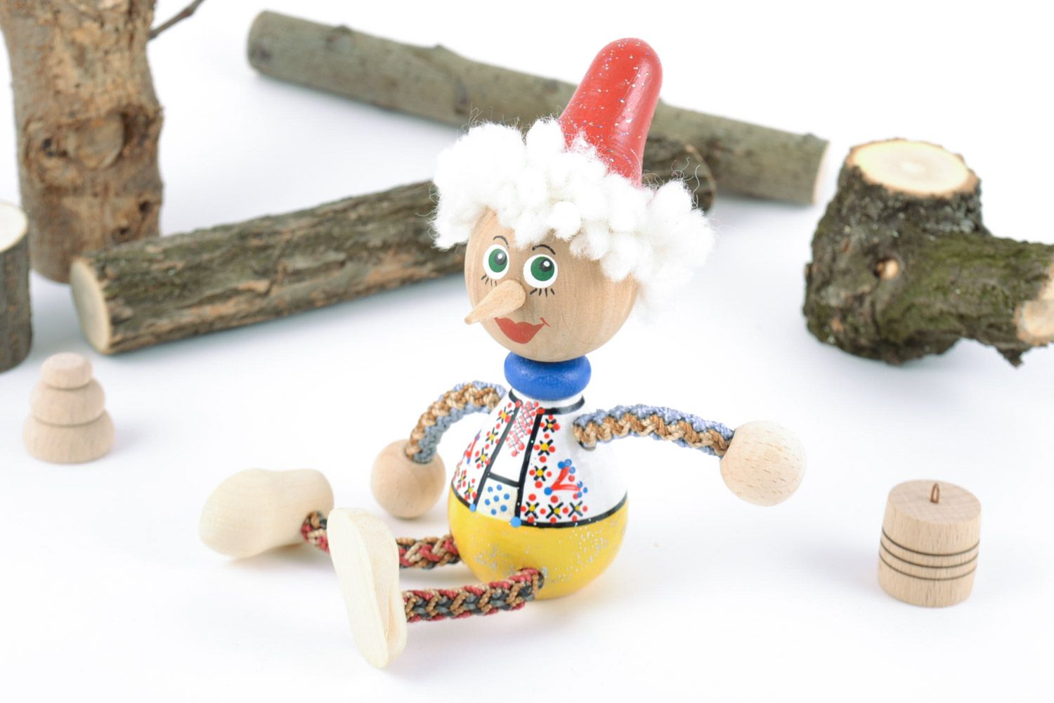Handmade small painted wooden toy in the shape of Pinocchio for children  photo 1