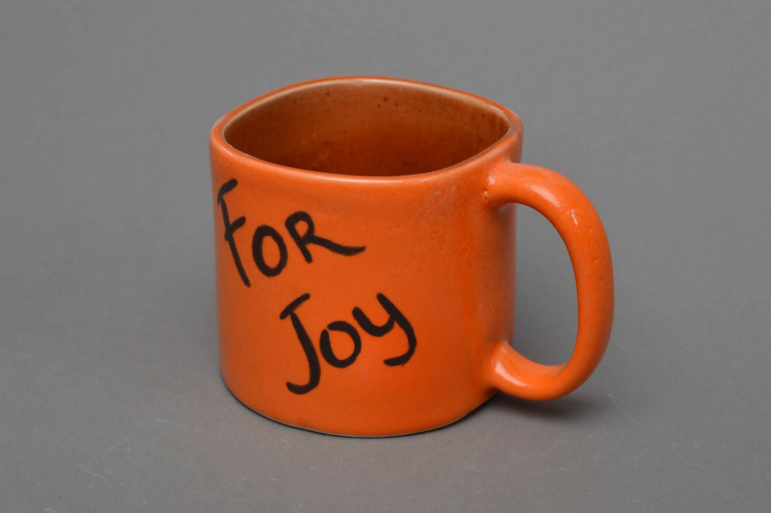 Ceramic cup for coffee in orange color glazed inside with smile face photo 1