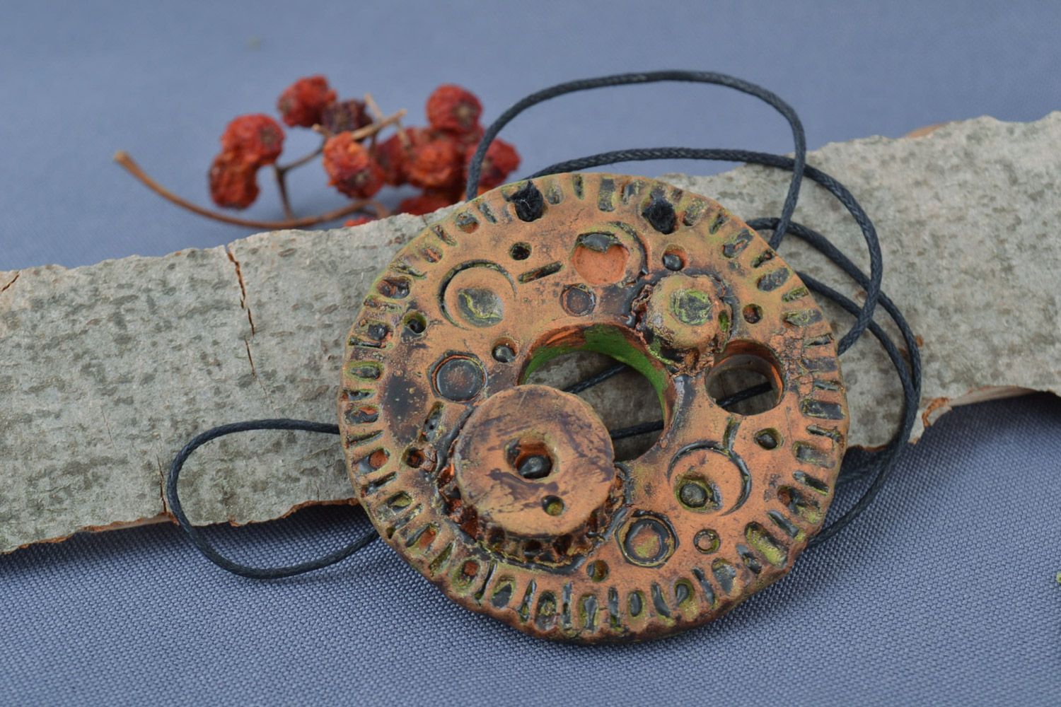 Handmade painted ceramic pendant in the shape of round clock mechanism on cord photo 1