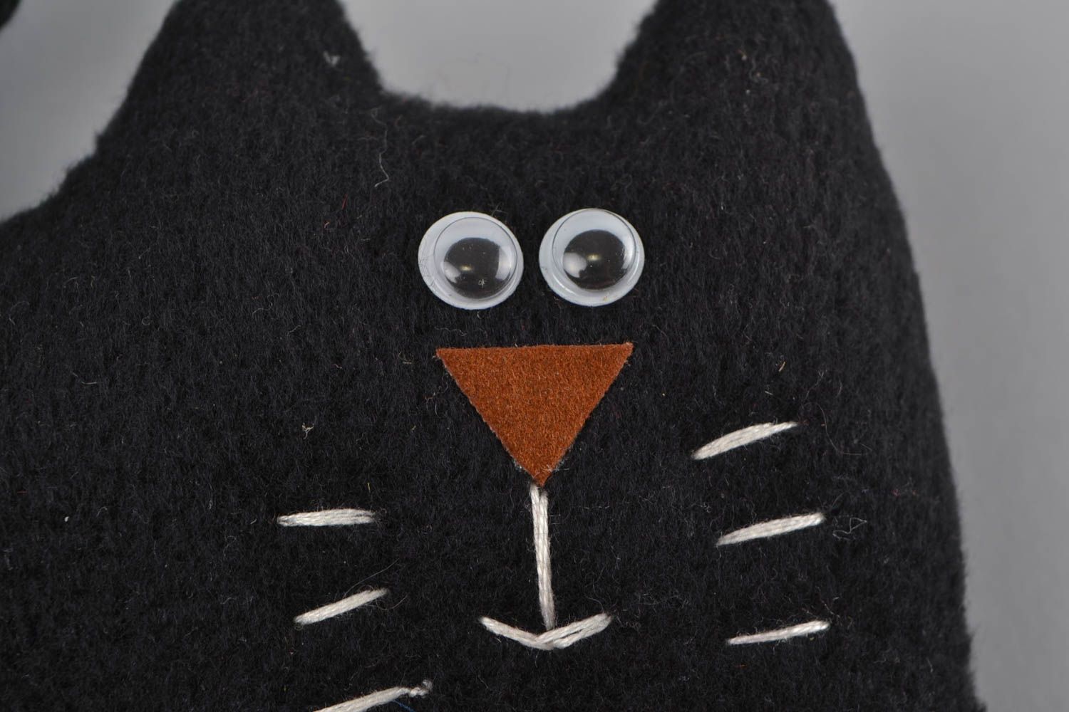 Handmade small soft toy sewn of black fleece in the shape of cat with red bow photo 4