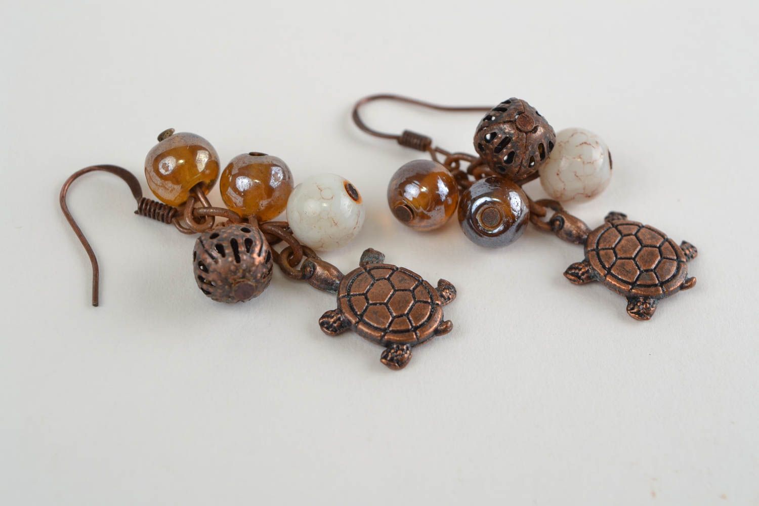 Handmade designer brown dangling earrings with glass beads and turtle charms photo 5