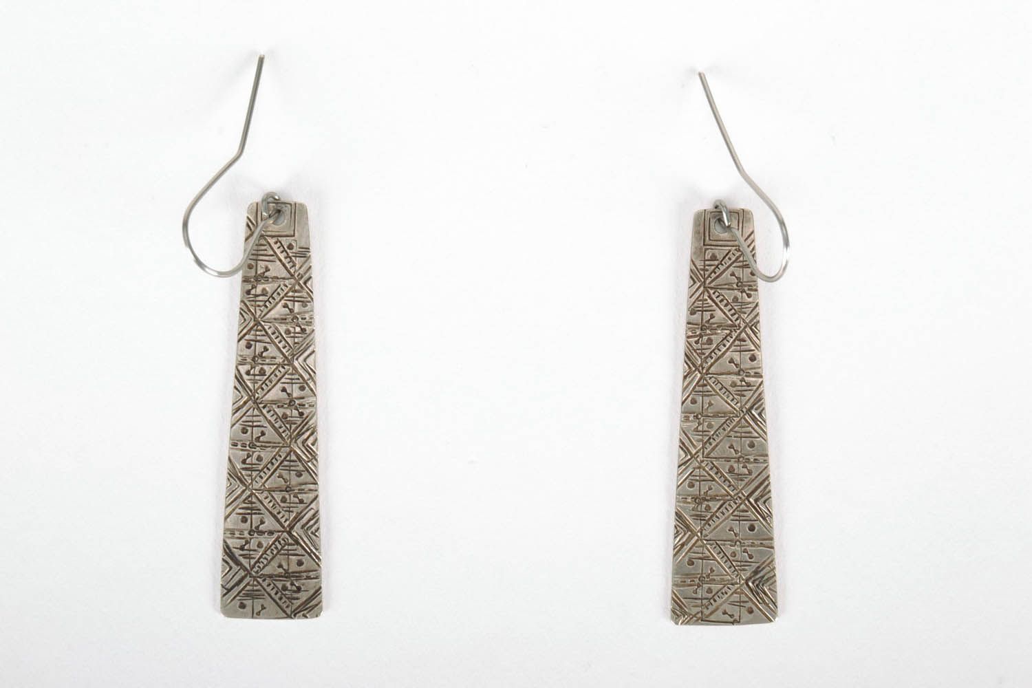 Earrings made using technique of stamping on melchior photo 2