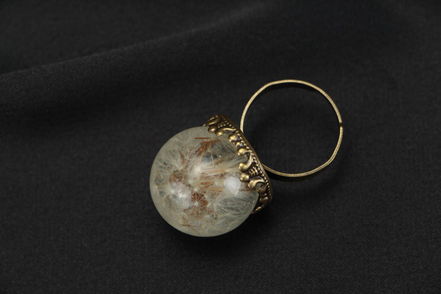Ring with a natural dandelion coated with jewelry resin photo 2