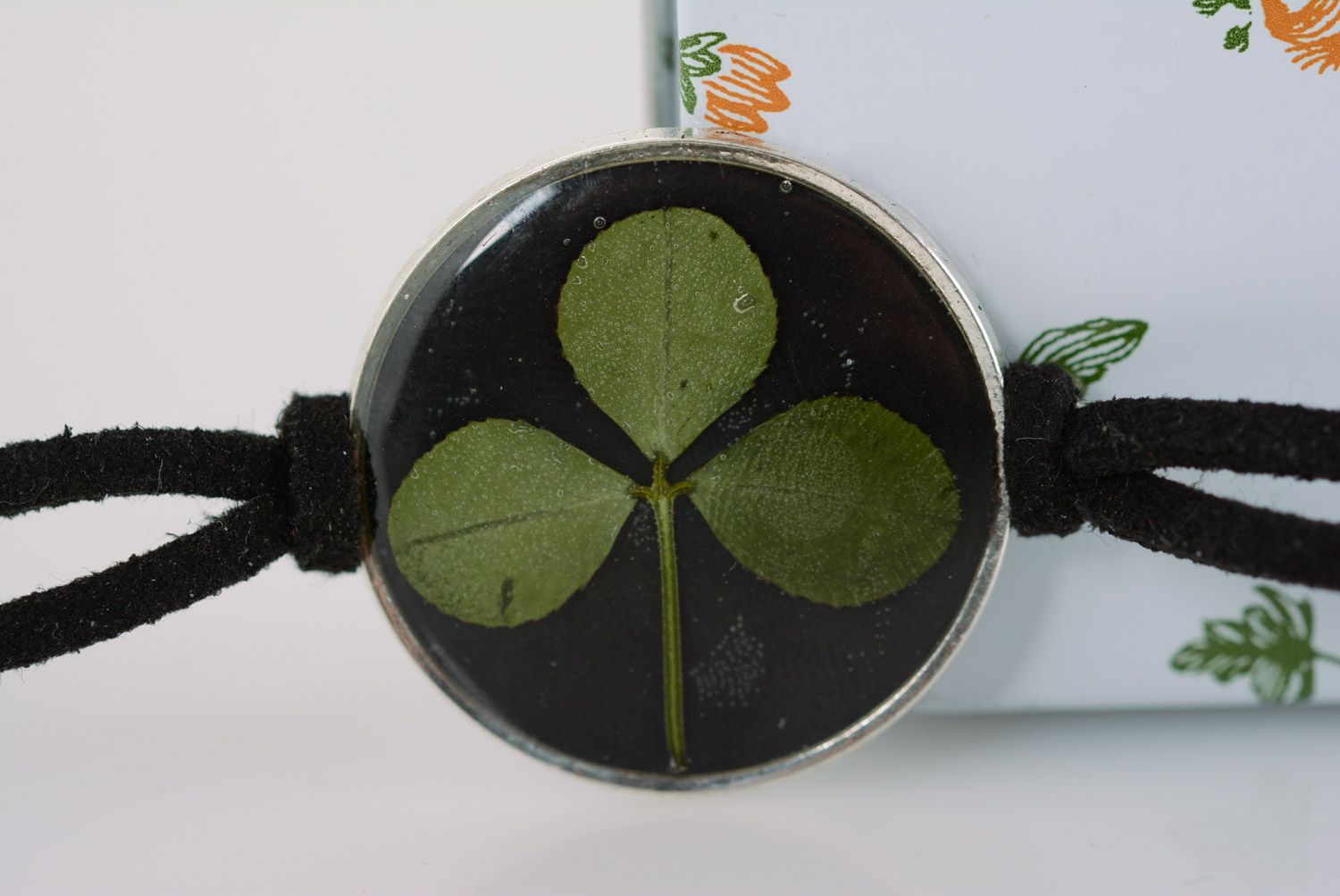 Handmade black wrist bracelet with clover in epoxy resin and leather cord  photo 1