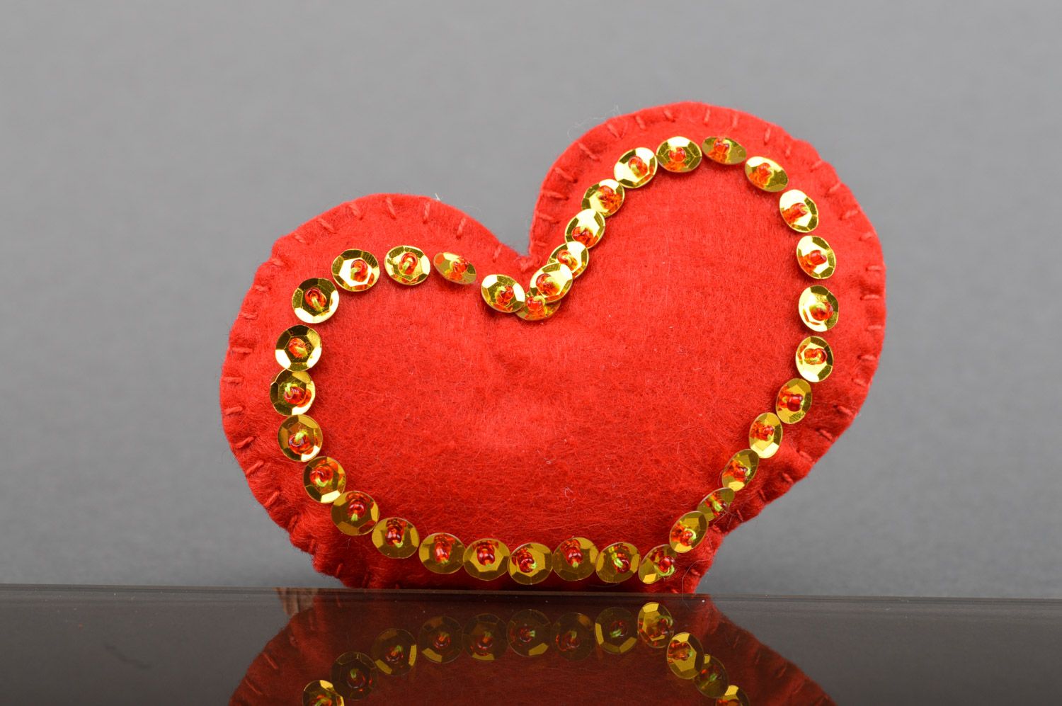 Handmade small red heart sewn of felt with spangles for interior decoration photo 1