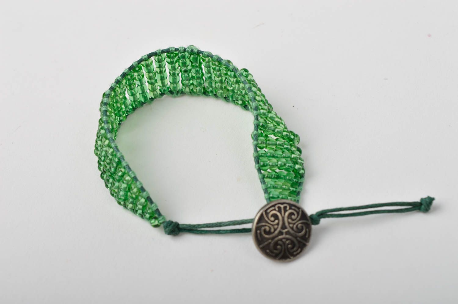 Light green homemade strand beaded bracelet with bronze token photo 3
