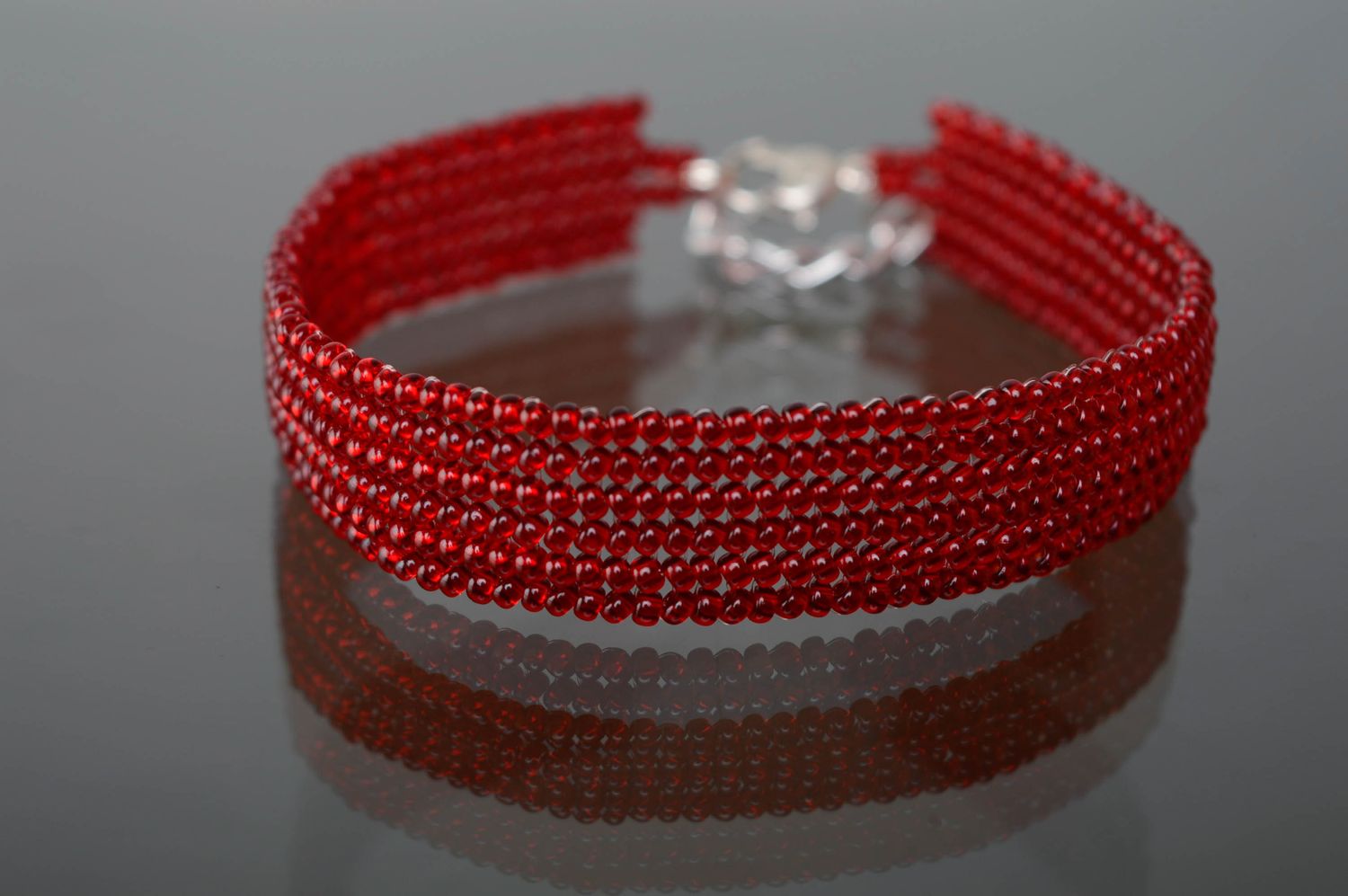 Red beaded bracelet with heart shaped charm photo 1