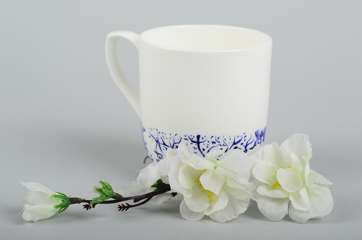 White porcelain tea cup with handle and handpainted blue pink painted pattern photo 1