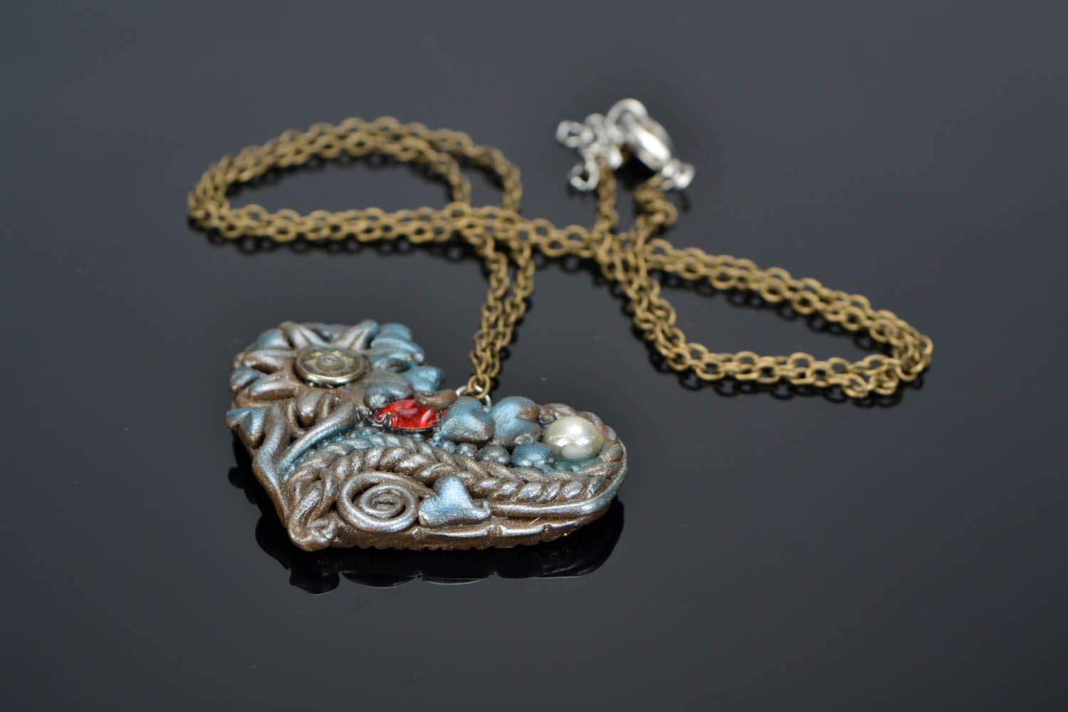 Pingente feito de cerâmica plástica decorado com elementos de bijuterias em uma cadeia Coração foto 1