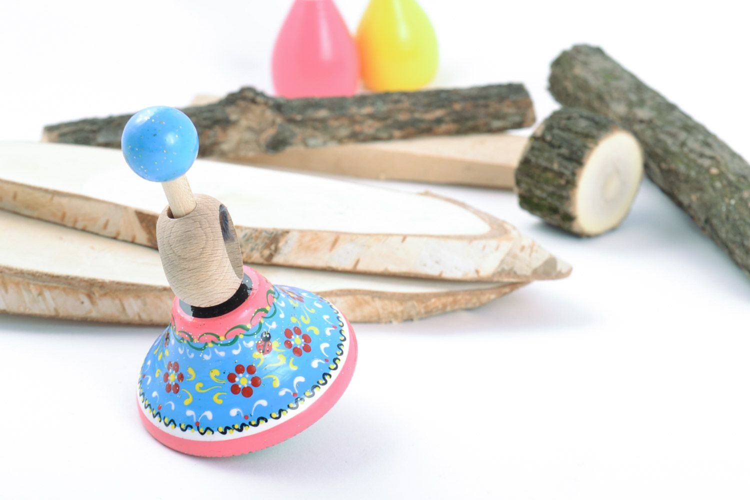 Homemade wooden eco friendly toy spinning top painted in blue and pink colors photo 1