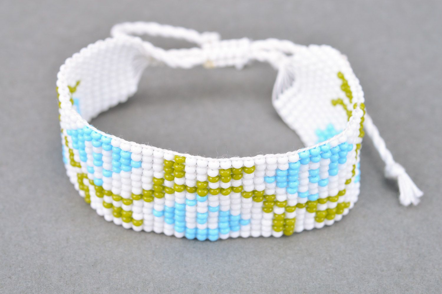 Tender light handmade wrist bracelet woven of beads with floral motives photo 2