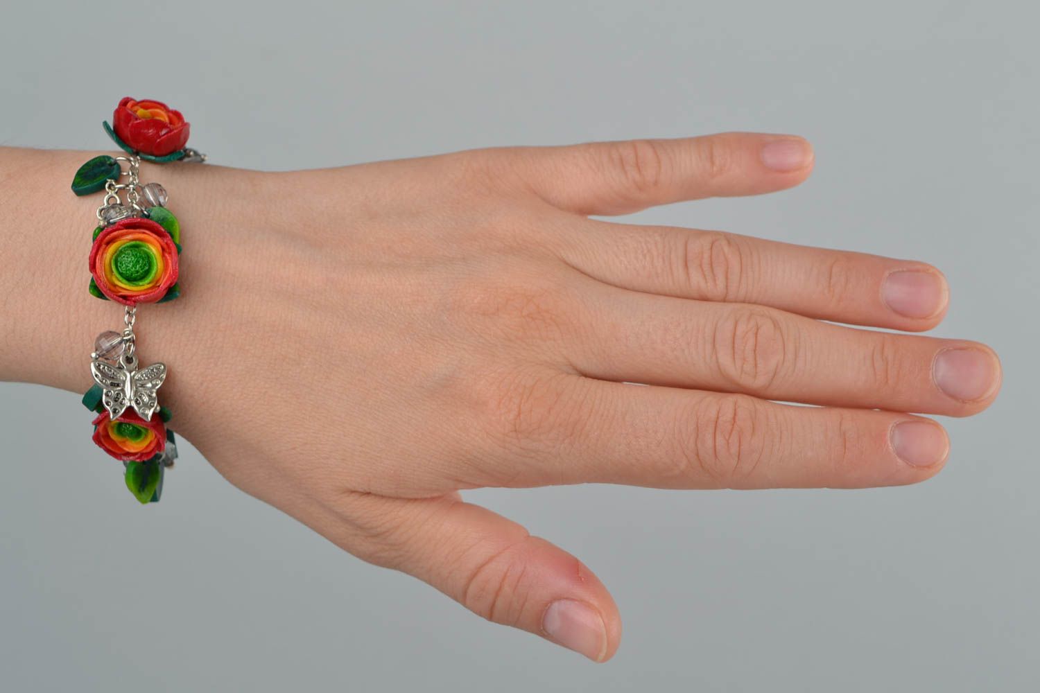 Beautiful women's handmade designer wrist bracelet with plastic flowers photo 3