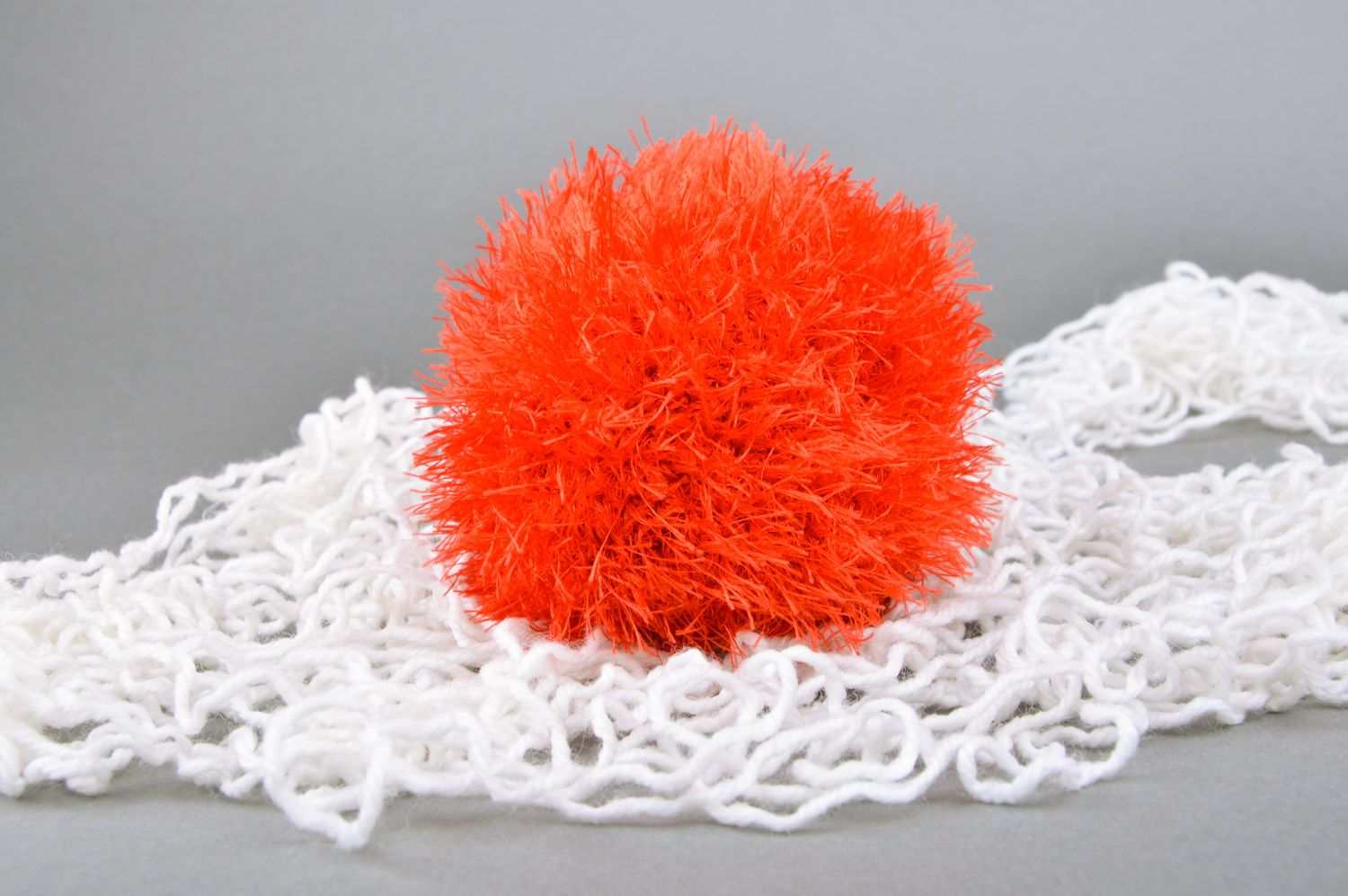 Handmade soft toy crocheted of red fluffy threads in the shape of ball for babies photo 1