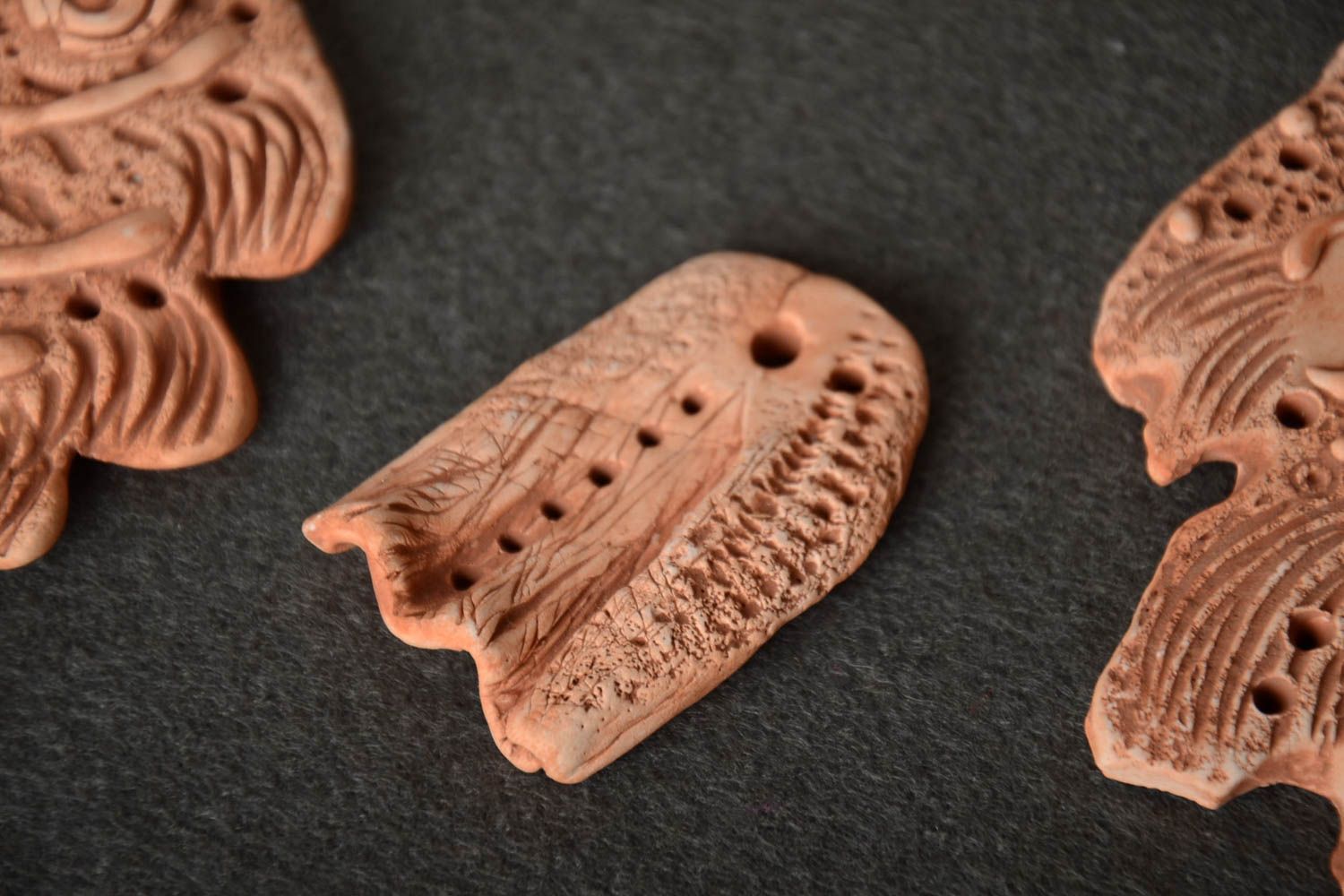 Homemade decorative ceramic element with perforation for pendant necklace making photo 1