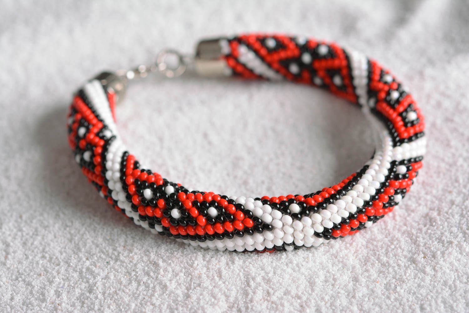 Handmade beaded adjustable cord bracelet with floral ornament in white and red colors photo 1
