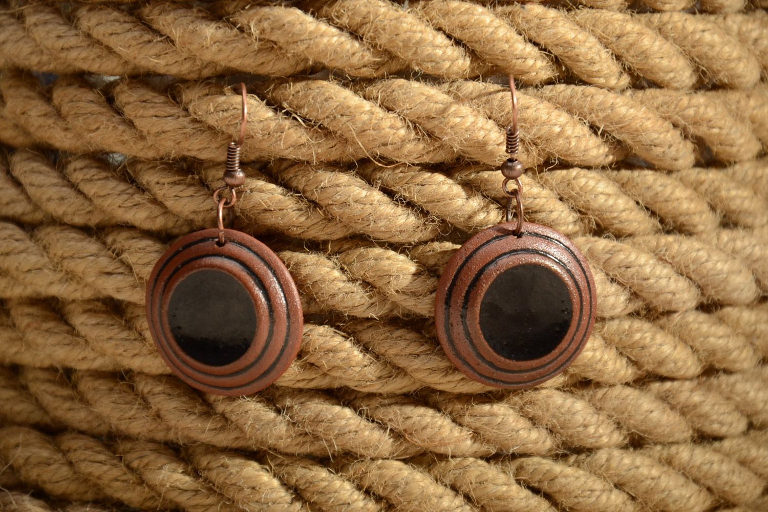 Handmade brown ceramic dangle earrings of round shape painted with enamels photo 1