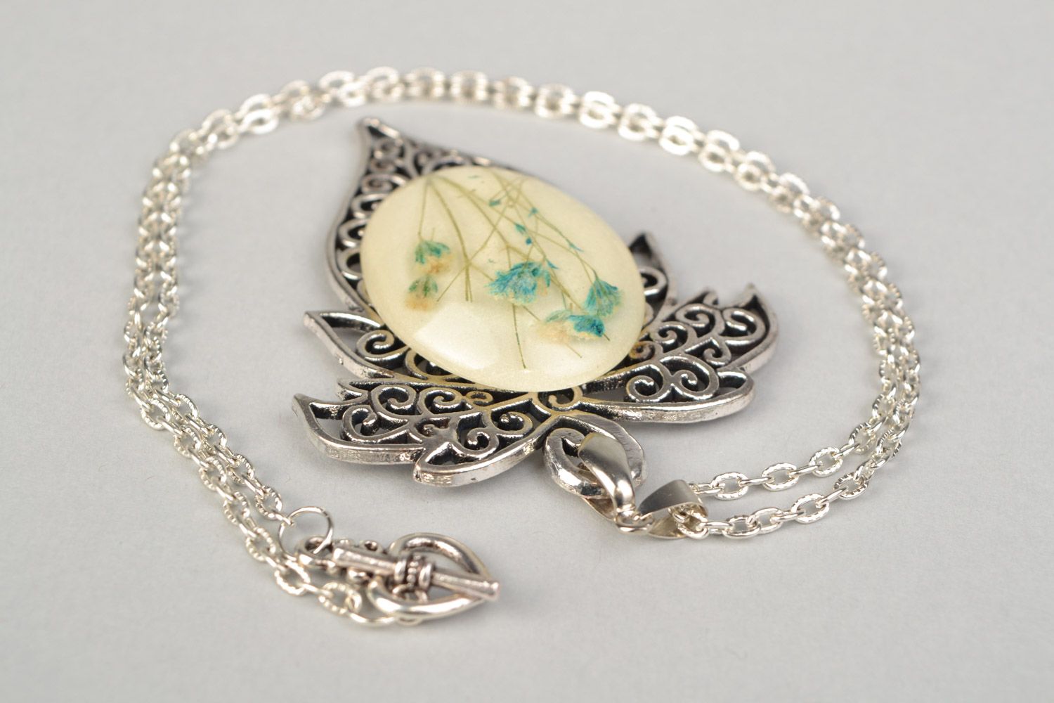 Handmade lacy leaf-shaped pendant with natural flowers in epoxy resin on chain photo 4