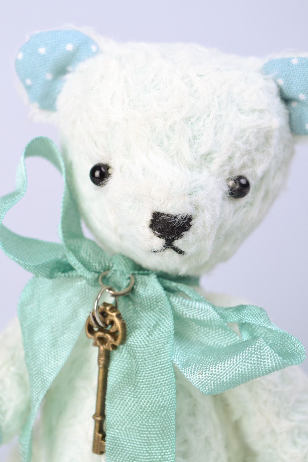 Handmade designer soft toy bear in light color palette with bow and key charm photo 3