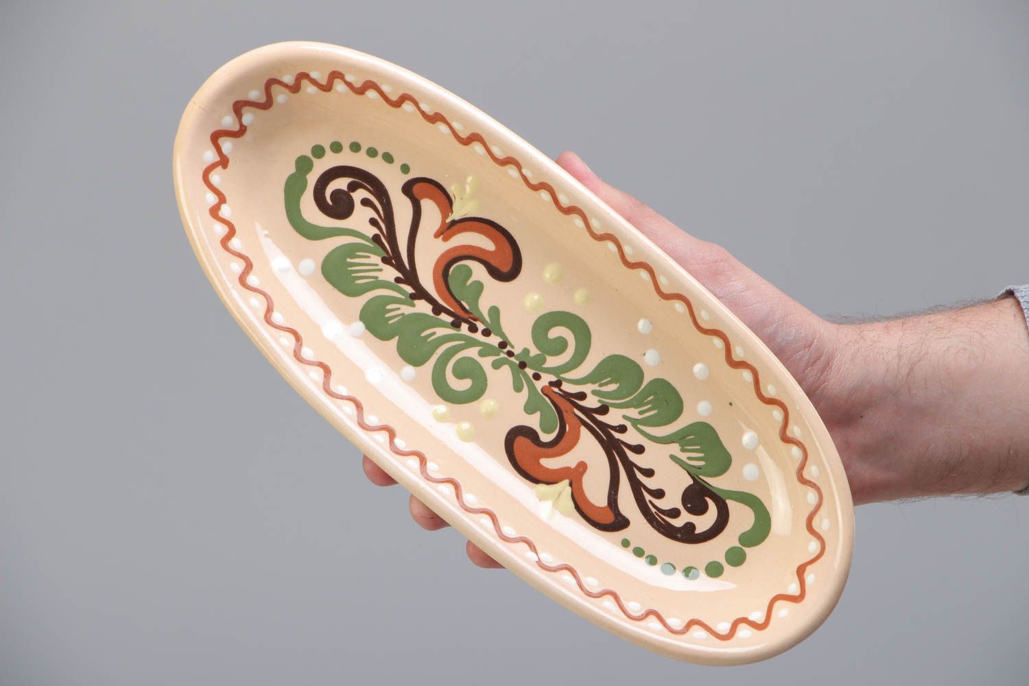Homemade long ceramic dish ornamented with colorful glaze for serving fish photo 5