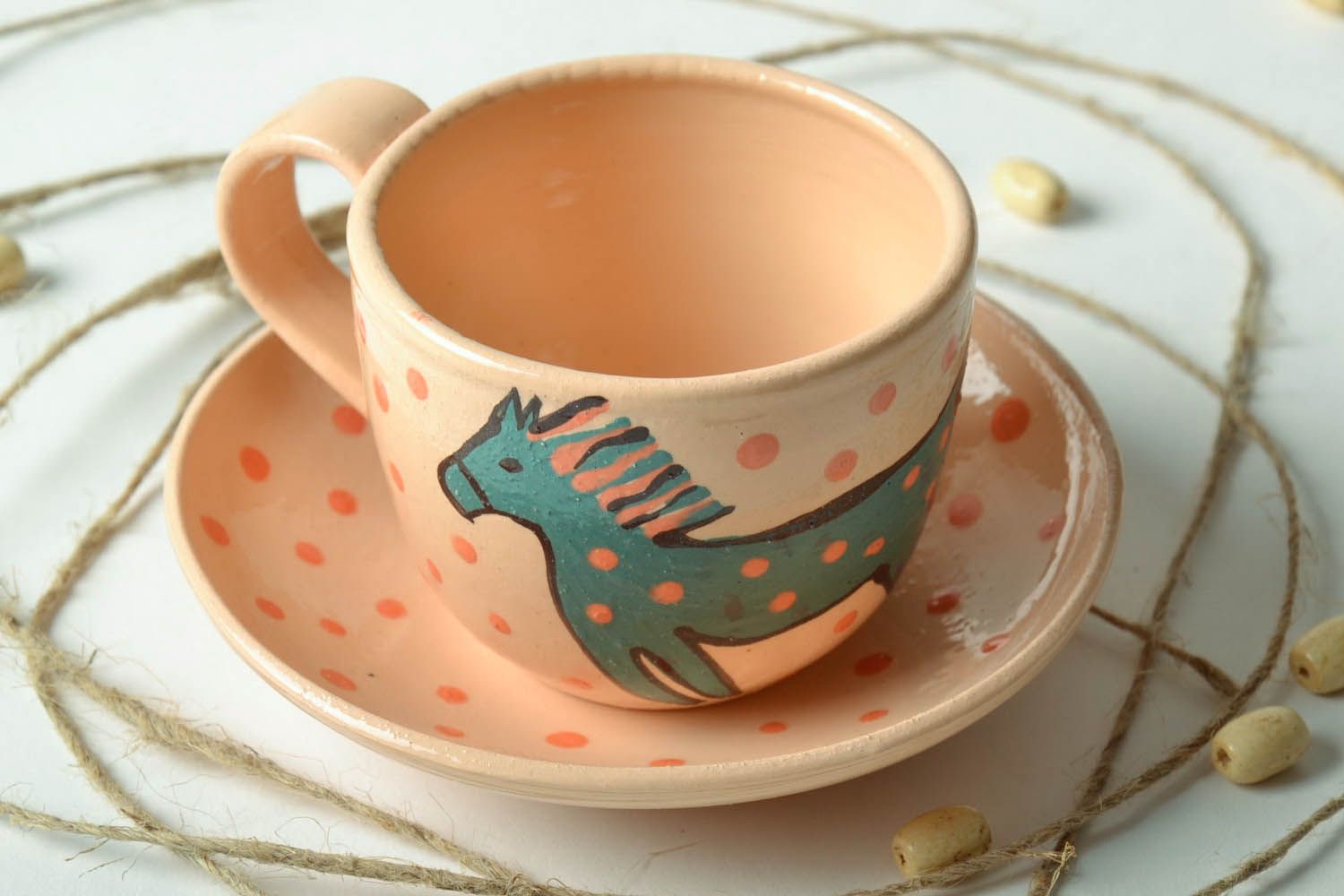 Kids' ceramic drinking cup with handle, saucer, and horse pattern photo 1