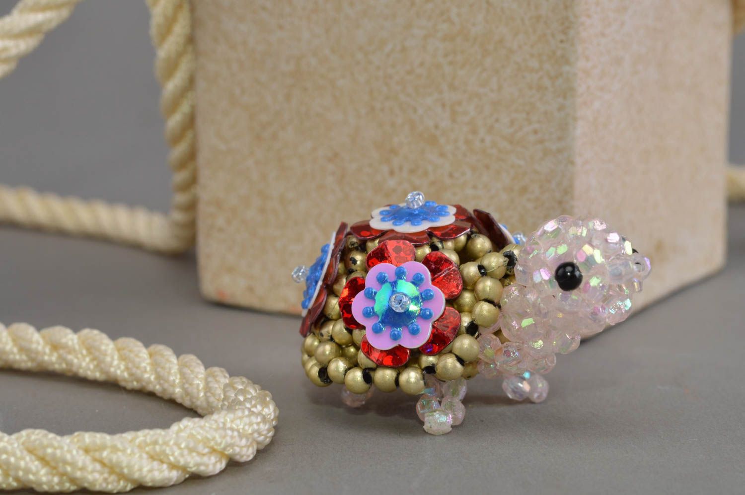 Handmade designer miniature bead woven figurine of turtle with flowers on armor photo 1