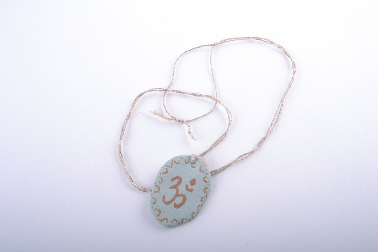 Handmade designer white clay neck pendant painted with engobes with ohm symbol photo 3