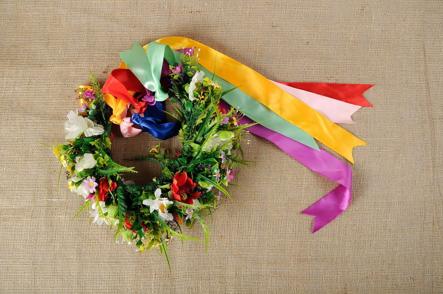 Wreath with artificial flowers and satin ribbons photo 3