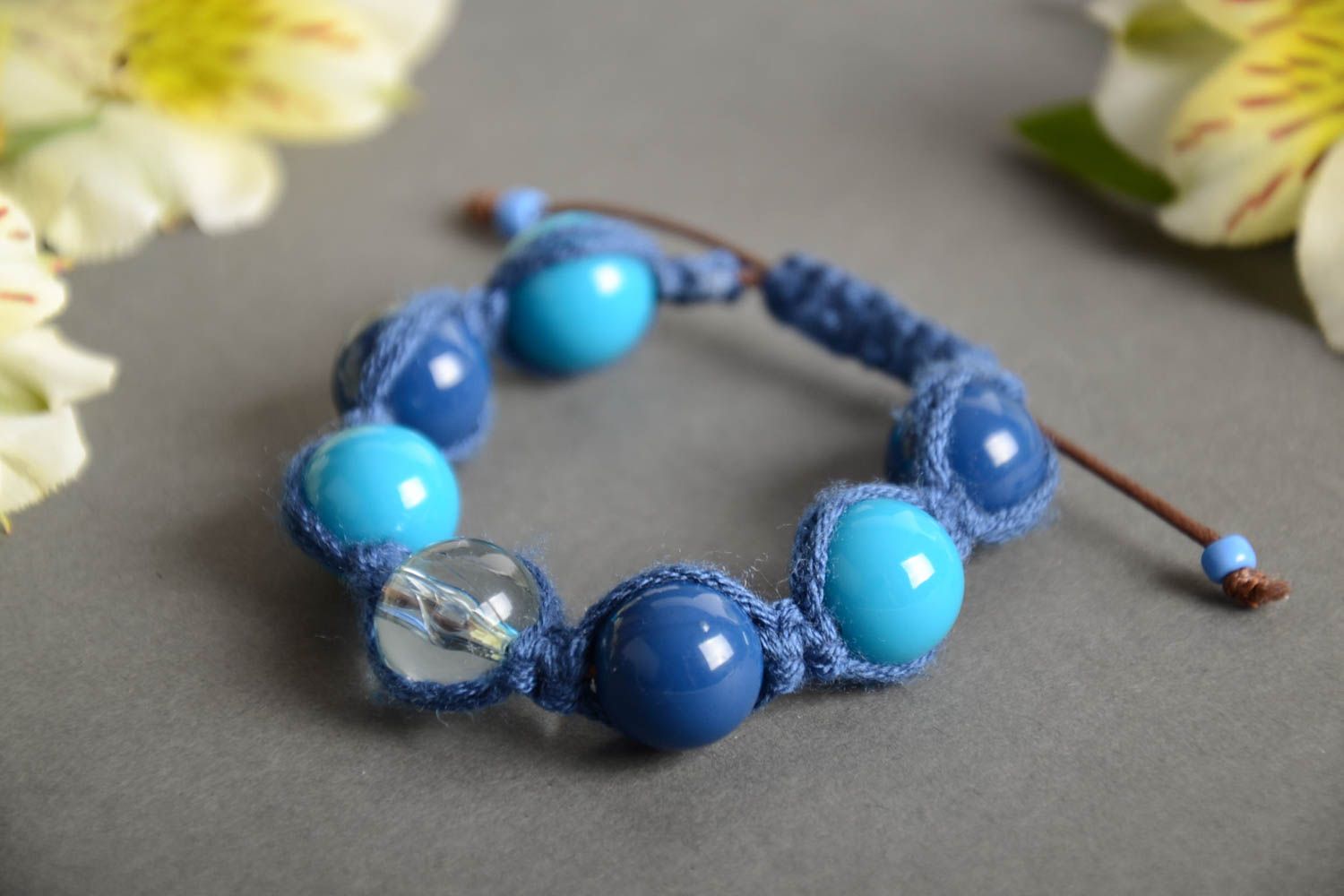Handmade wrist bracelet crocheted of cord and plastic beads in blue color shades photo 1
