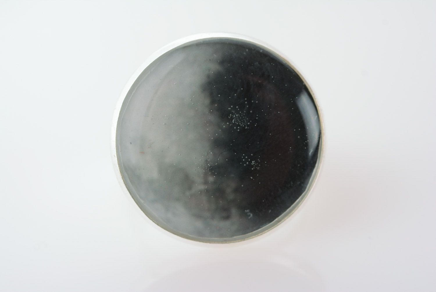 Handmade black metal round ring with flower petal coated with epoxy resin photo 2