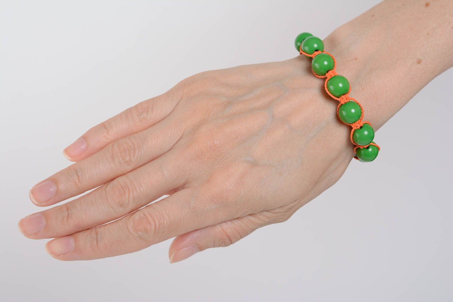 Handmade bracelet with plastic beads on waxed cord green-orange accessory photo 5