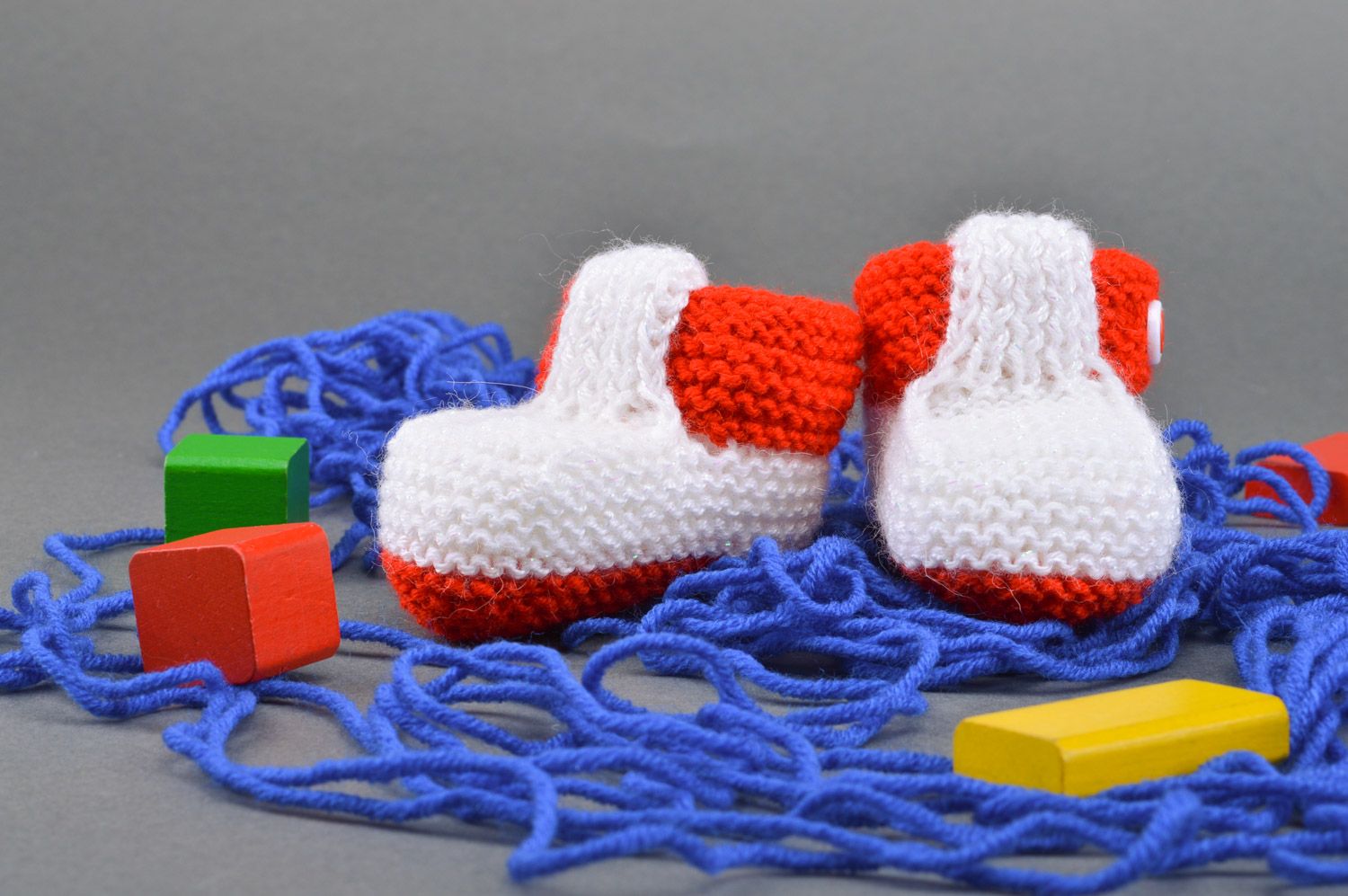 Red and white handmade knitted half-woolen baby booties with buttons photo 1