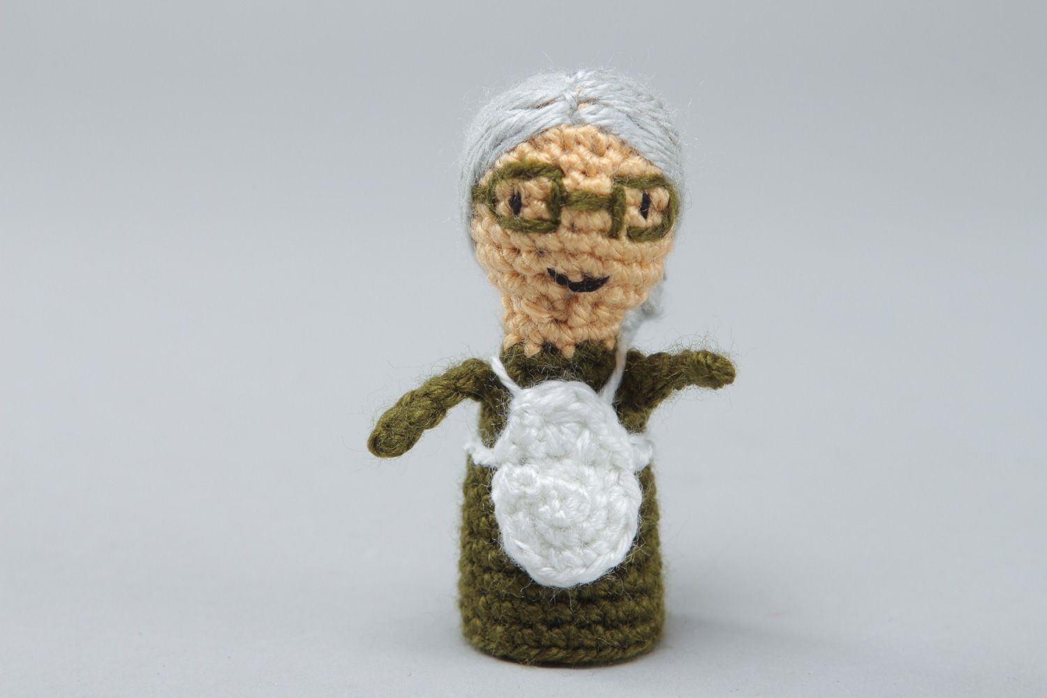 Handmade finger puppet toy in the shape of old woman crocheted of acrylic threads photo 1