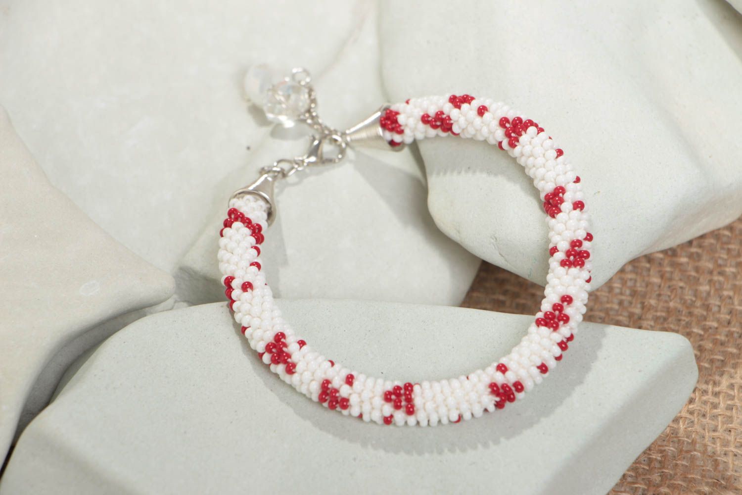 Handmade designer white and red beaded cord women's wrist bracelet with charms  photo 1
