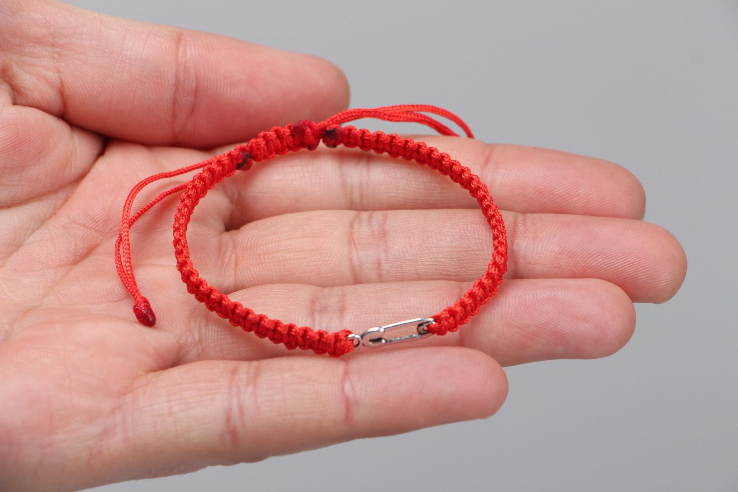 Handmade friendship bracelet woven of synthetic thread of red color with ties photo 3