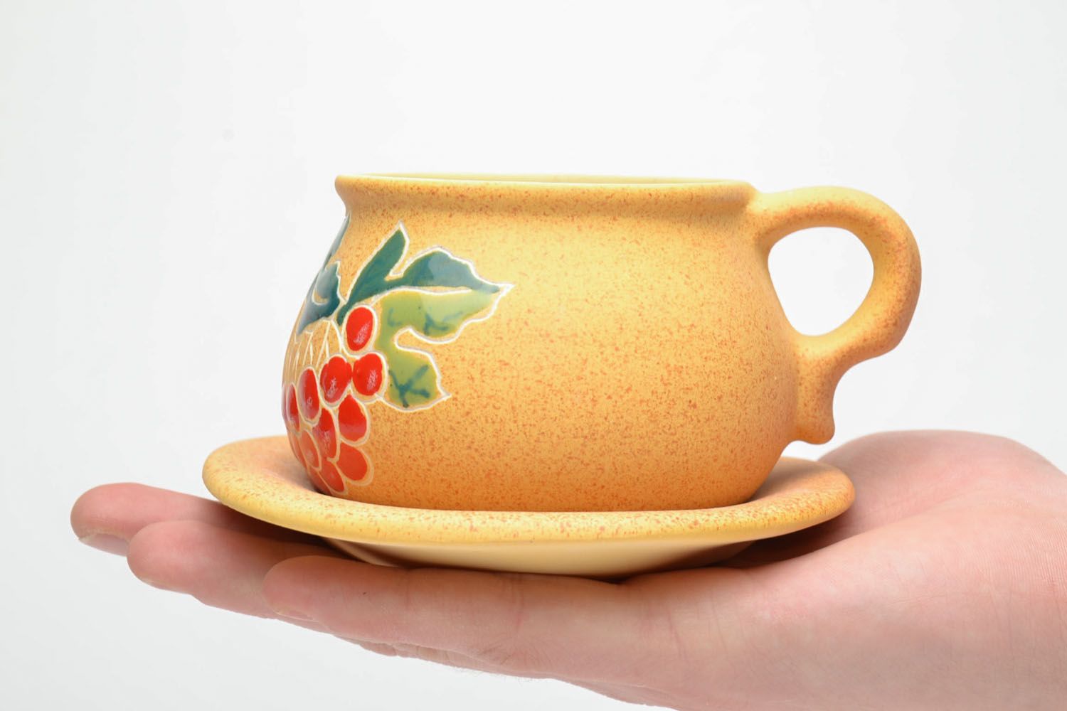 Yellow clay art teacup with handle and saucer and red floral pattern photo 5