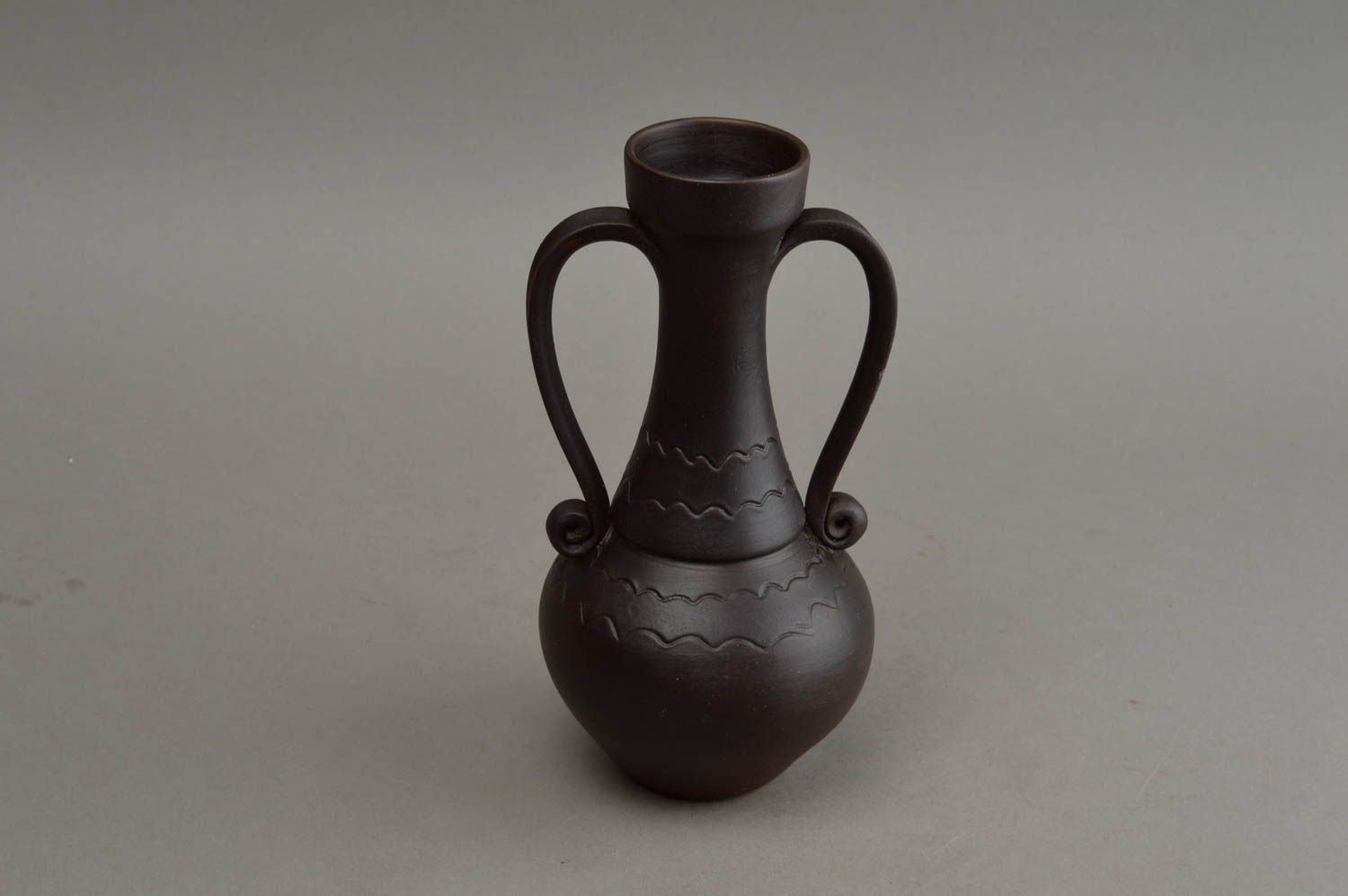 Schwarze handgemachte Vase aus Ton mit Musterung und zwei gedrehten Griffen foto 3
