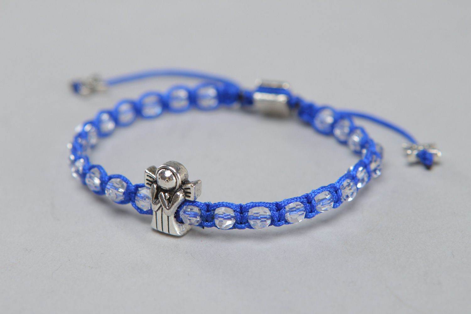 Handmade friendship wrist bracelet woven of blue cord with beads and metal element photo 2