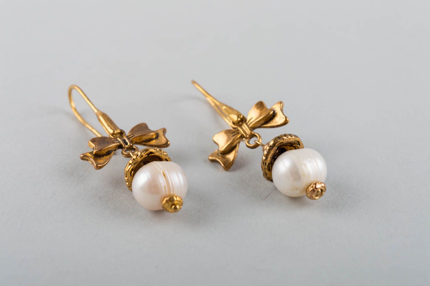 Handmade coquettish dangling earrings with latten bows and white pearl beads photo 3