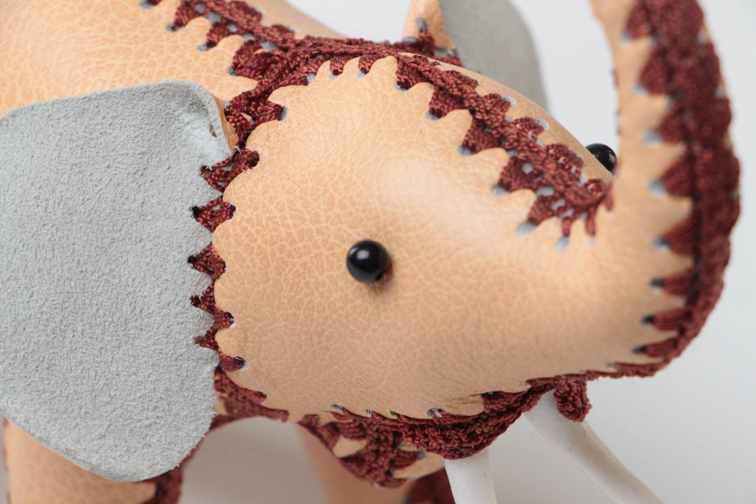 Handmade designer small soft toy elephant sewn of genuine leather of beige color photo 3