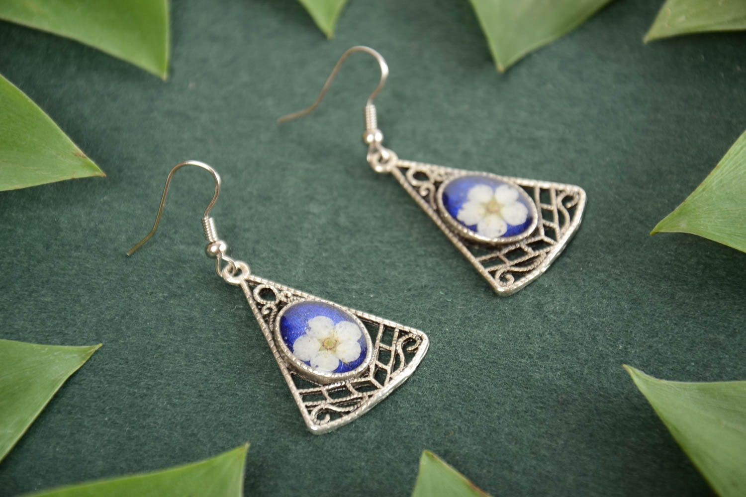 Handmade metal triangle dangling earrings with real flowers in epoxy resin photo 1