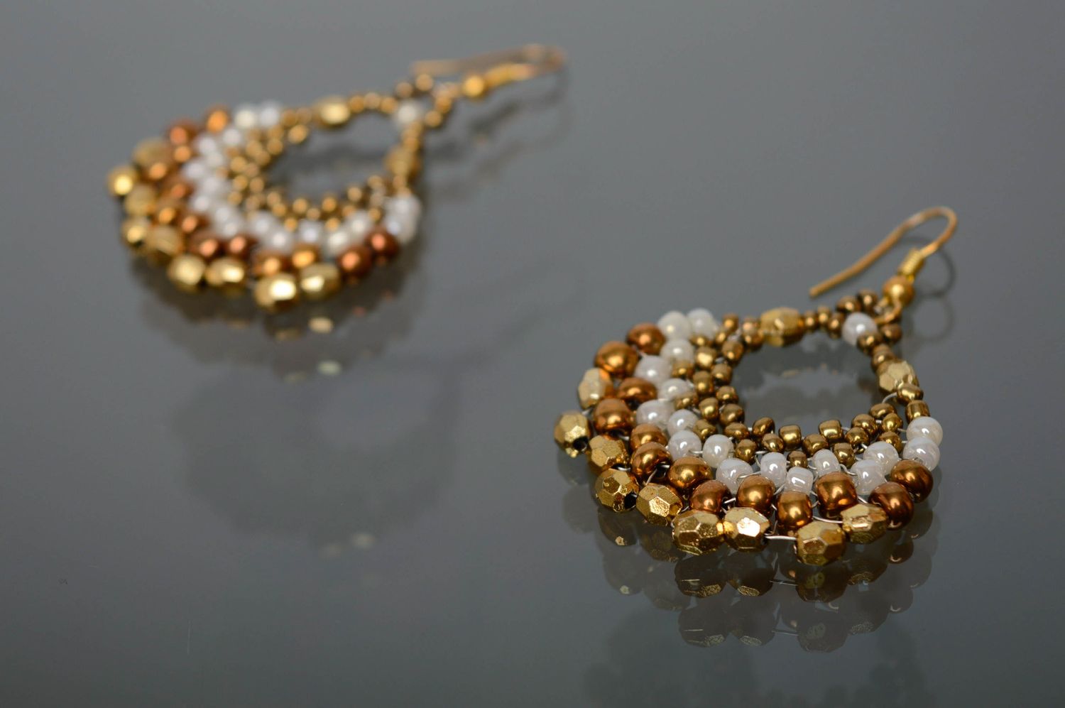Handmade beaded earrings of white and golden colors photo 1
