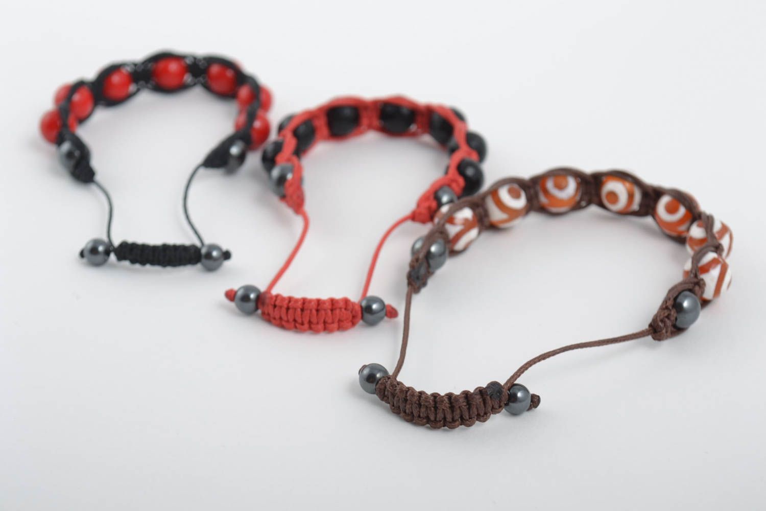 Set of three strand bracelets on red, brown, black cords with red, black, white, and brown beads for women photo 4