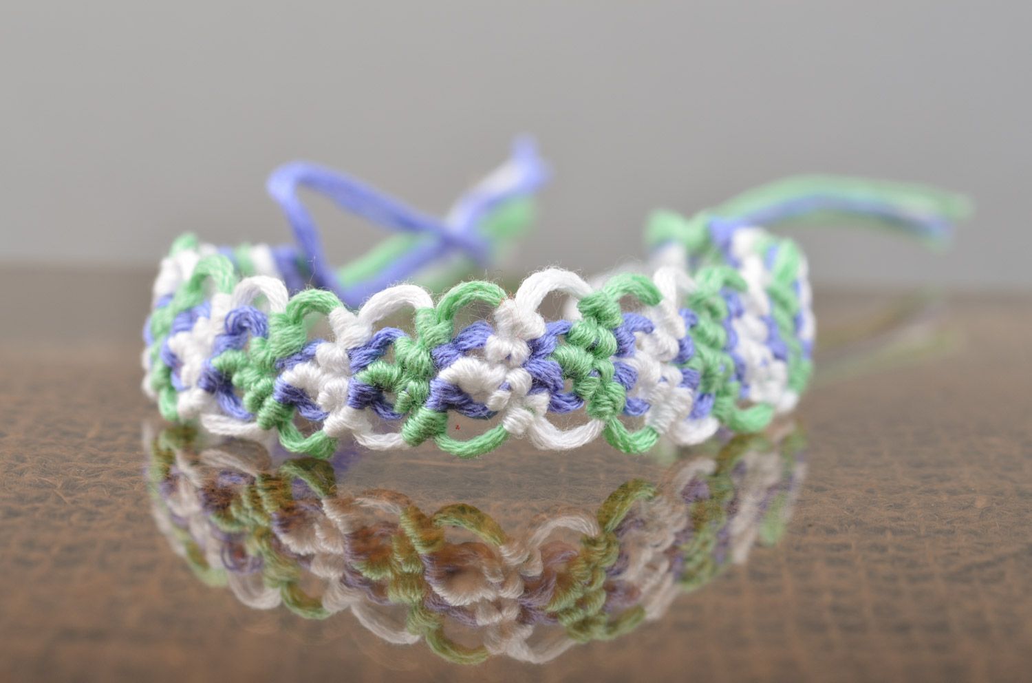 Thin handmade friendship wrist bracelet woven of embroidery floss in tender colors photo 1