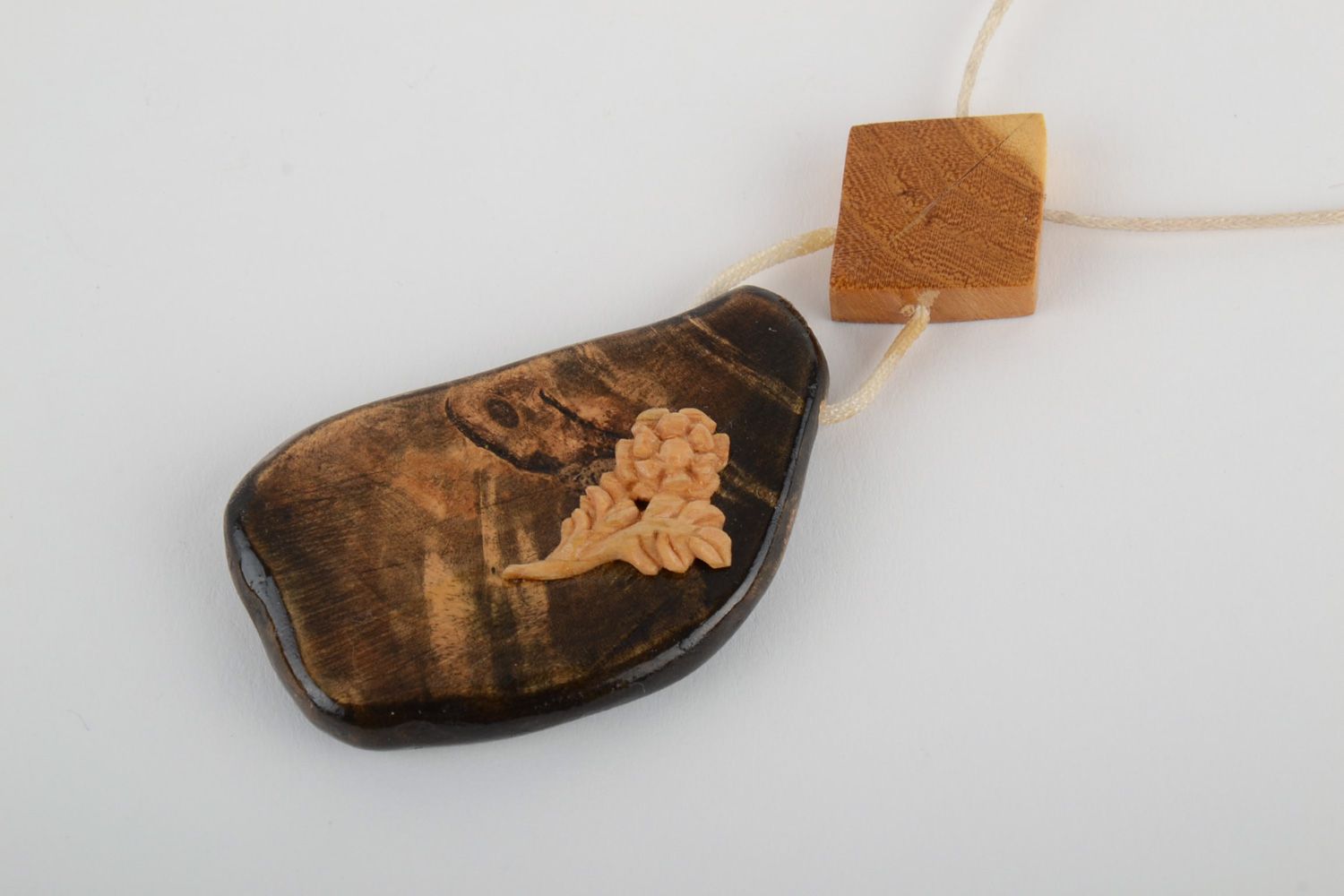 Beautiful handmade neck pendant carved of wood and varnished with synthetic cord photo 3