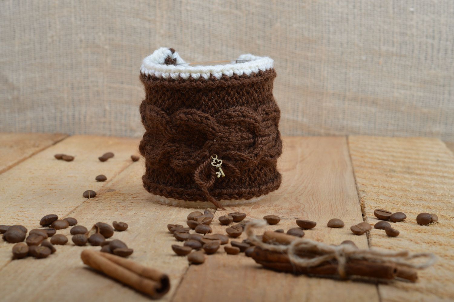 Cute handmade cup cozy knitted of brown woolen threads with metal key charm photo 1