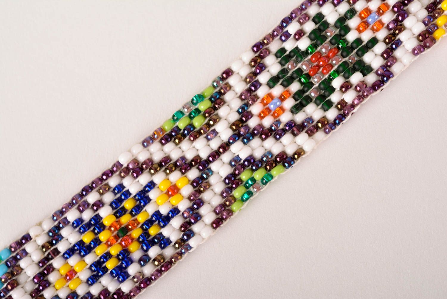 Knitted beaded white cord strand bracelet with ethnic ornament photo 3