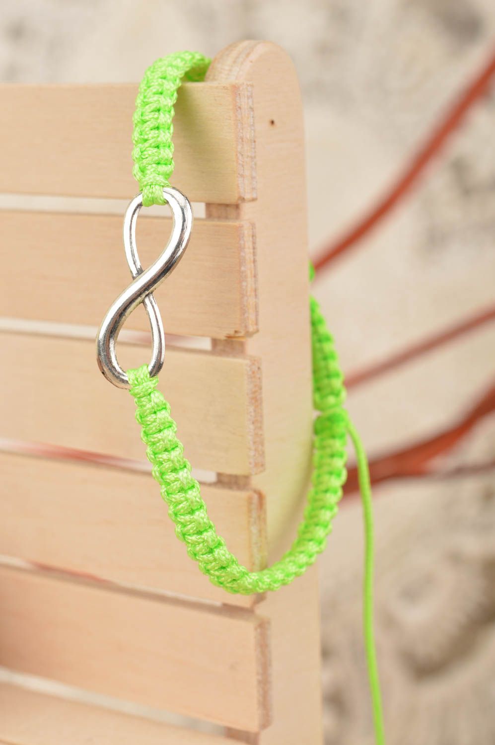 Beautiful handmade woven silk thread bracelet of lime color with metal charm photo 1