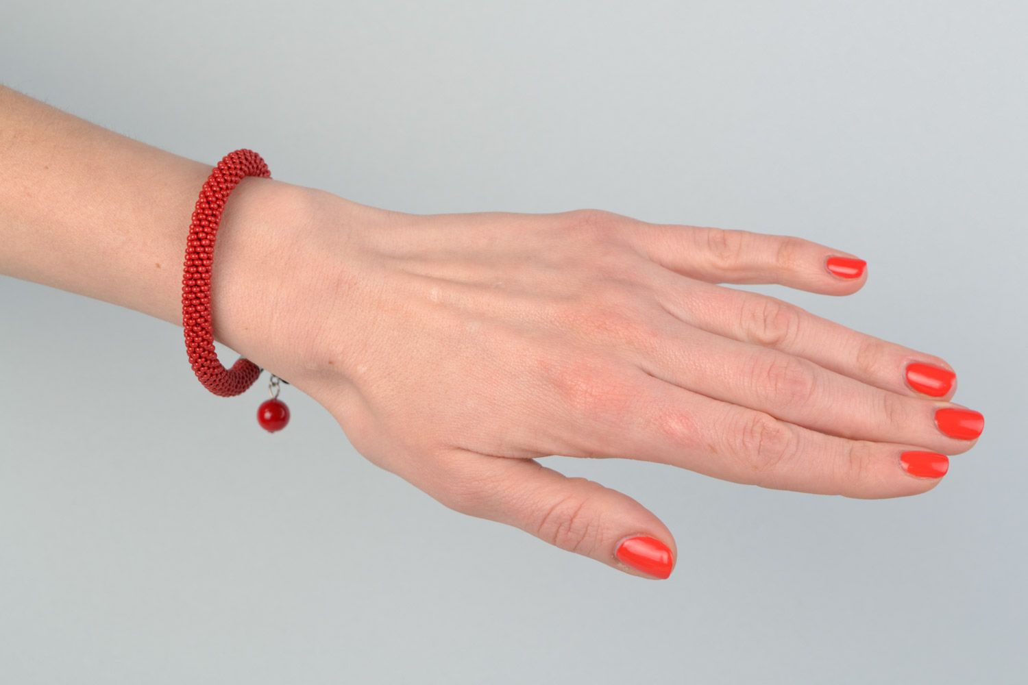 Handmade bright red beaded cord women's wrist bracelet with glass beads photo 1